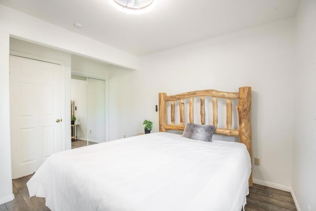 bedroom with wood-type flooring and a closet