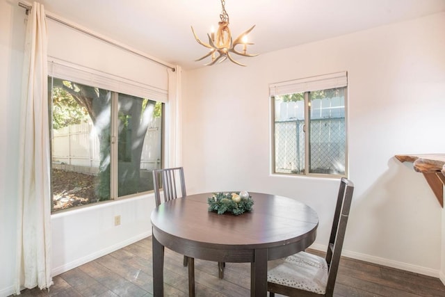 dining area with an inviting chandelier and dark hardwood / wood-style floors