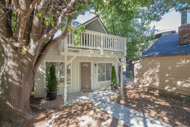 view of front of home with a balcony and a patio area