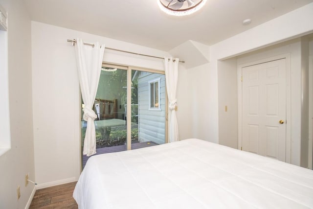 bedroom with access to outside and hardwood / wood-style floors