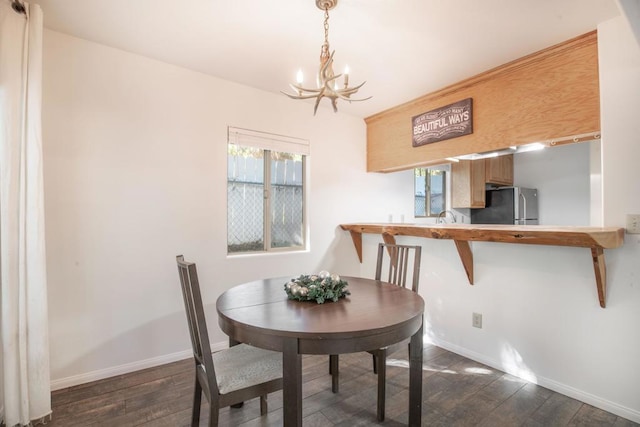 dining room featuring dark hardwood / wood-style flooring, a chandelier, and sink