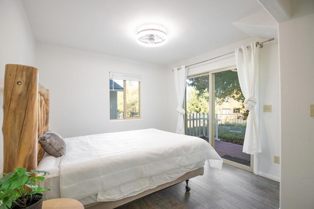 bedroom with dark wood-type flooring and access to outside