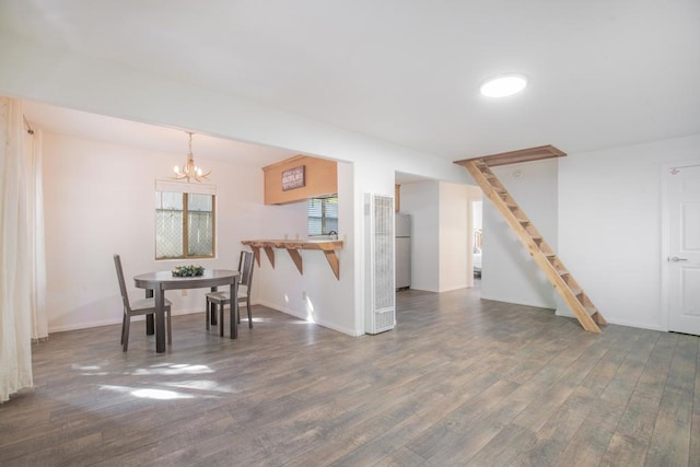 dining room featuring dark hardwood / wood-style flooring and a notable chandelier