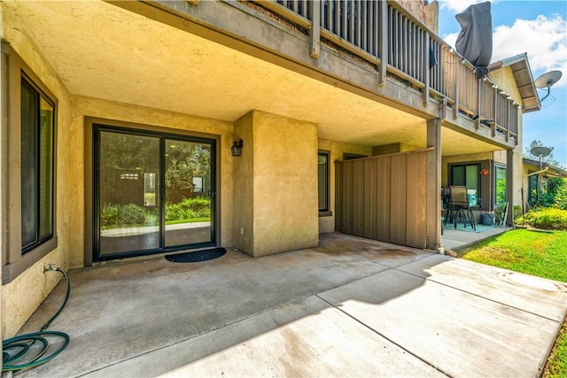 property entrance featuring a patio area and a balcony