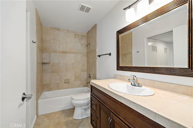 full bathroom with tile patterned floors, vanity, tiled shower / bath combo, and toilet