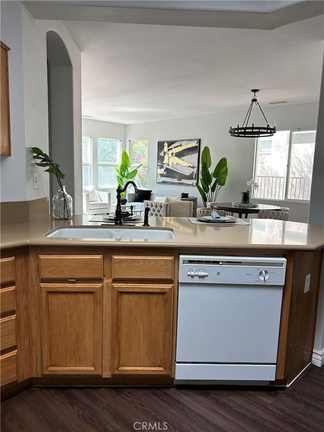 kitchen featuring dishwasher, decorative light fixtures, dark hardwood / wood-style floors, and sink