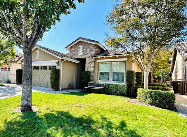 view of front facade with a garage and a front lawn