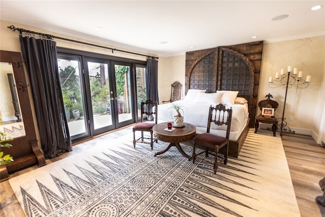 sitting room with french doors, ornamental molding, and hardwood / wood-style floors