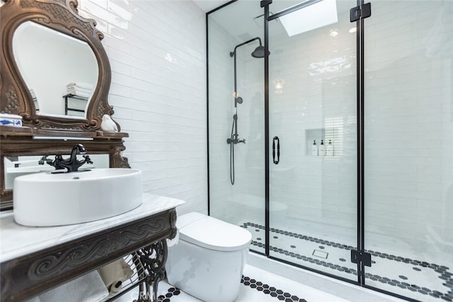 bathroom with toilet, walk in shower, vanity, and a skylight