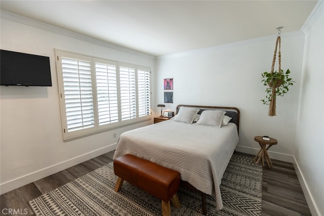 bedroom with crown molding and dark hardwood / wood-style floors