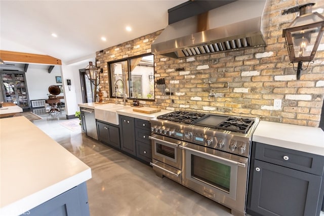 kitchen with sink, wall chimney exhaust hood, appliances with stainless steel finishes, and concrete flooring