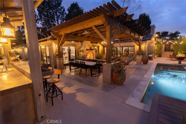 patio terrace at dusk with a pergola