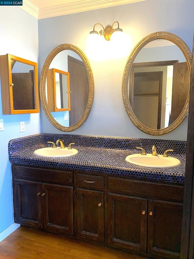 bathroom featuring hardwood / wood-style floors, vanity, and ornamental molding