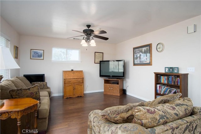 living room featuring dark hardwood / wood-style flooring and ceiling fan