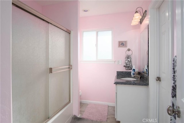 full bathroom featuring vanity, combined bath / shower with glass door, tile patterned floors, and toilet