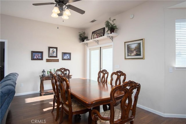 dining space with dark wood-type flooring and ceiling fan