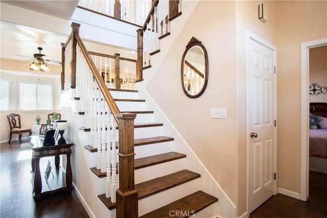 stairway with hardwood / wood-style flooring and ceiling fan