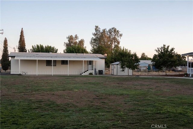 view of front of home with a storage shed