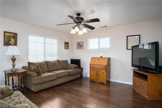 living room featuring dark wood-type flooring and ceiling fan