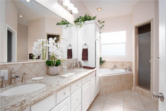 bathroom featuring vanity, plus walk in shower, and tile patterned flooring