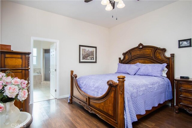 bedroom with dark wood-type flooring, ceiling fan, and ensuite bathroom