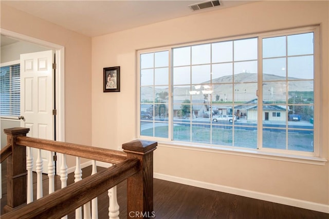 unfurnished bedroom with dark hardwood / wood-style flooring and a mountain view