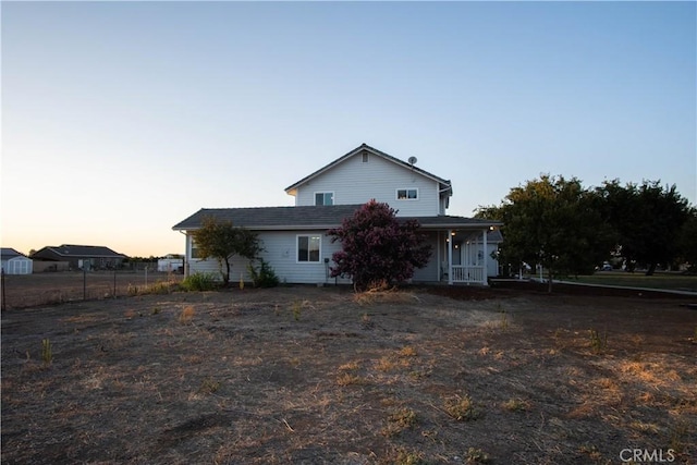 view of back house at dusk