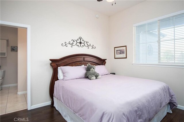 bedroom with dark hardwood / wood-style flooring and ceiling fan