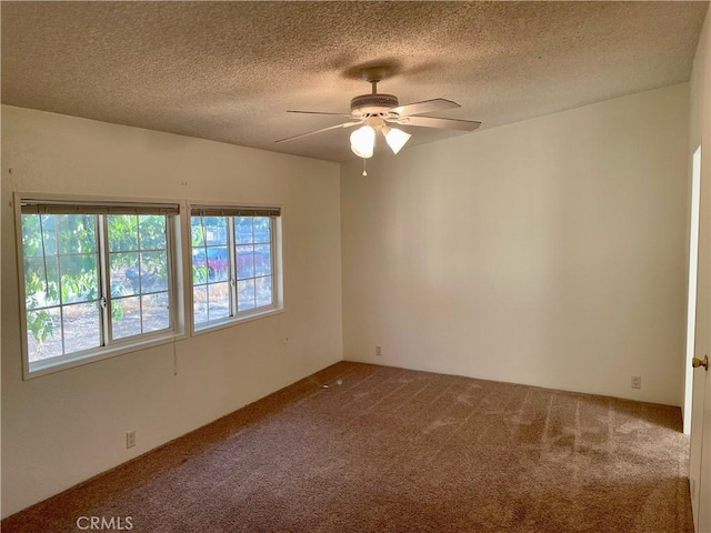 unfurnished room featuring ceiling fan, a textured ceiling, and carpet