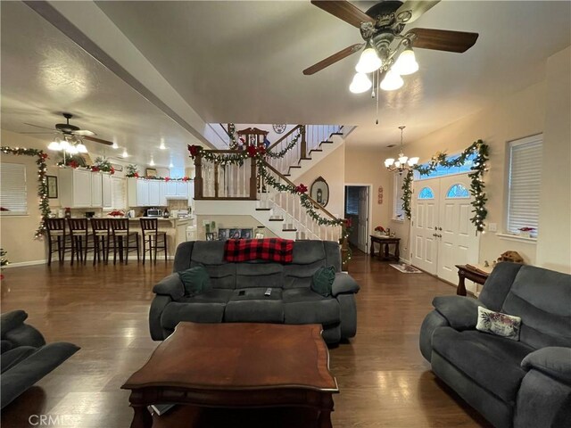 living room featuring dark hardwood / wood-style floors and ceiling fan with notable chandelier