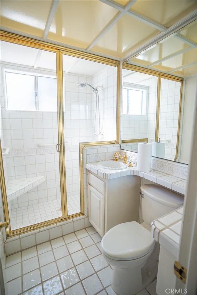 bathroom with tile patterned floors, walk in shower, toilet, and vanity