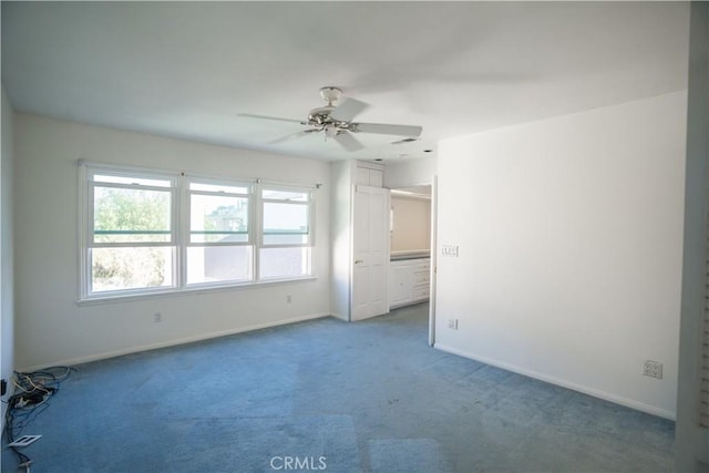 unfurnished room with ceiling fan and carpet flooring