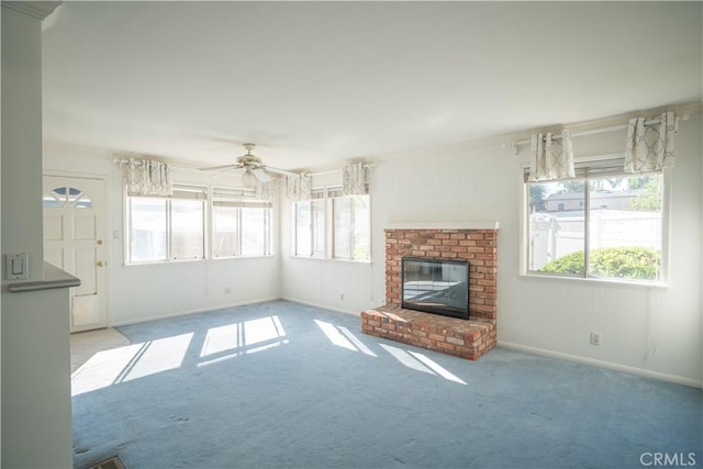 unfurnished living room featuring ceiling fan, light colored carpet, and a brick fireplace