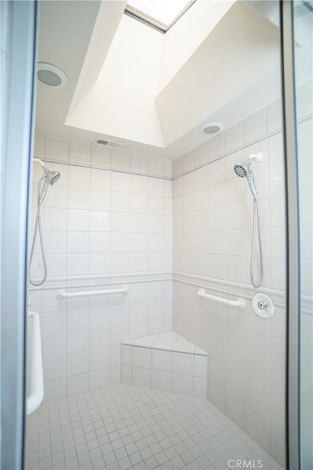 bathroom with a tile shower