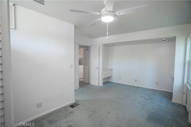 empty room featuring washer / dryer, ceiling fan, and carpet flooring