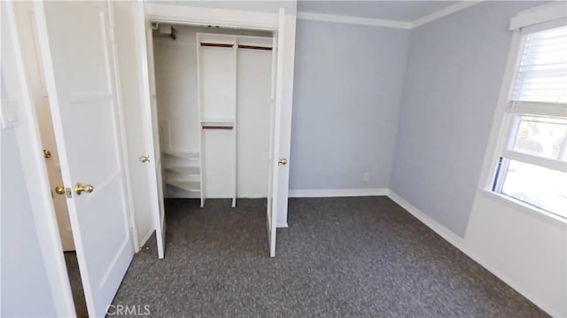 unfurnished bedroom featuring multiple windows and a closet