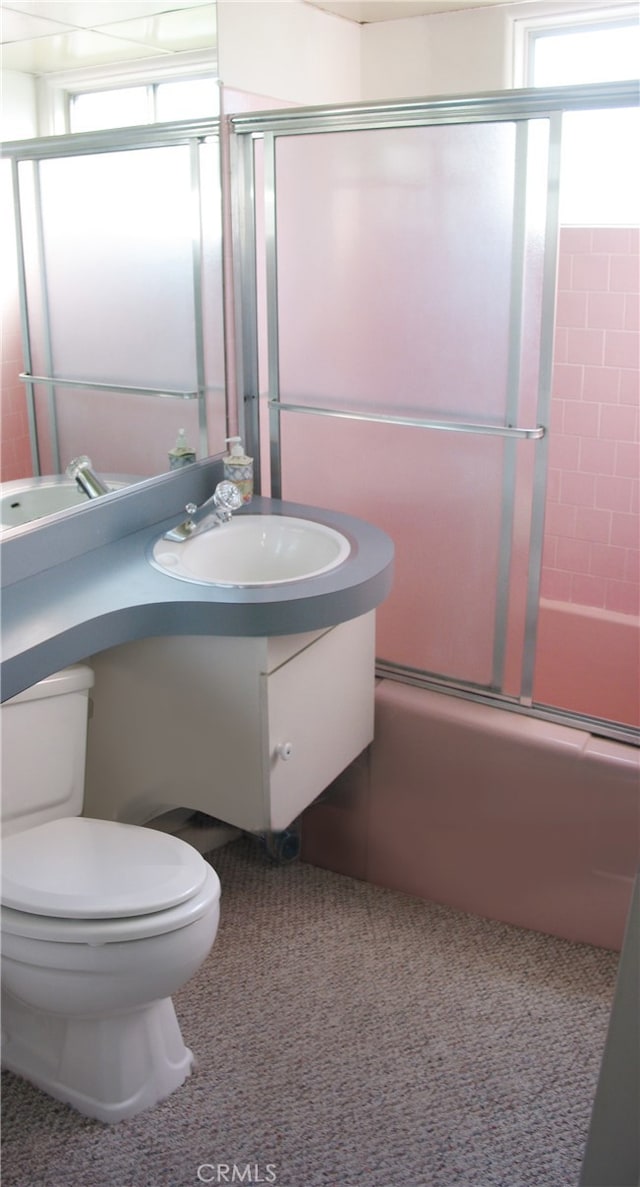 full bathroom featuring shower / bath combination with glass door, vanity, and toilet