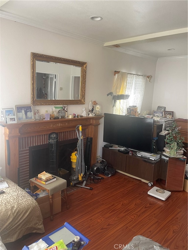 living room with ornamental molding, hardwood / wood-style floors, and a fireplace