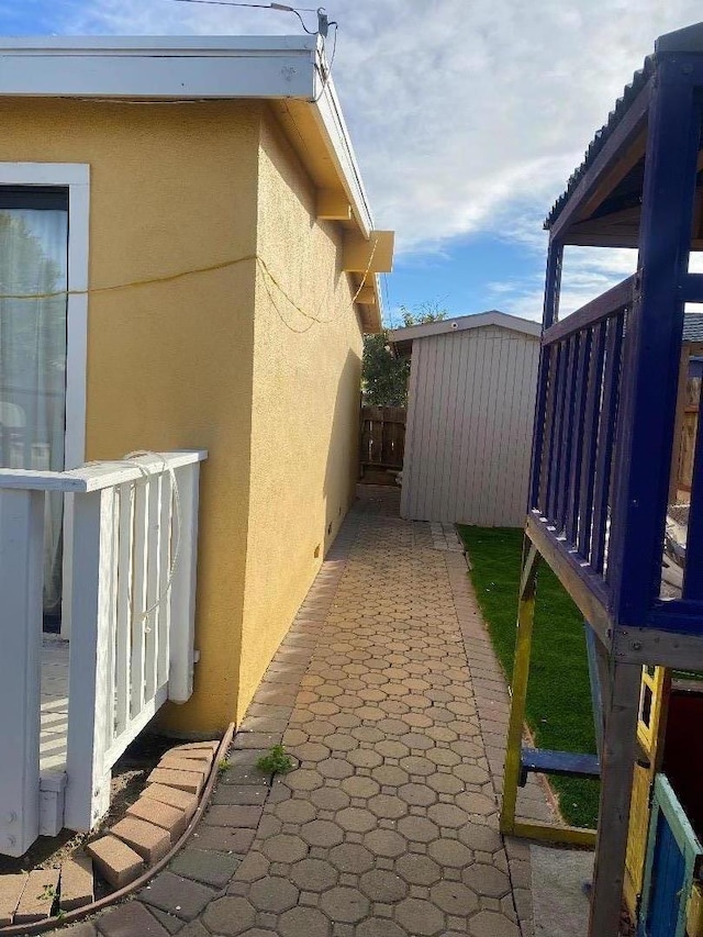 view of side of home featuring a storage unit