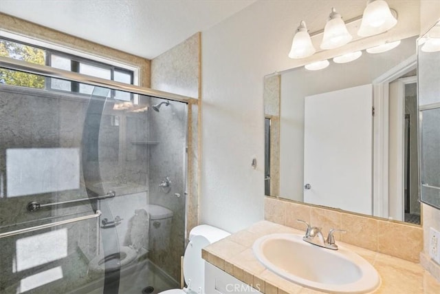 bathroom with vanity, toilet, and an enclosed shower