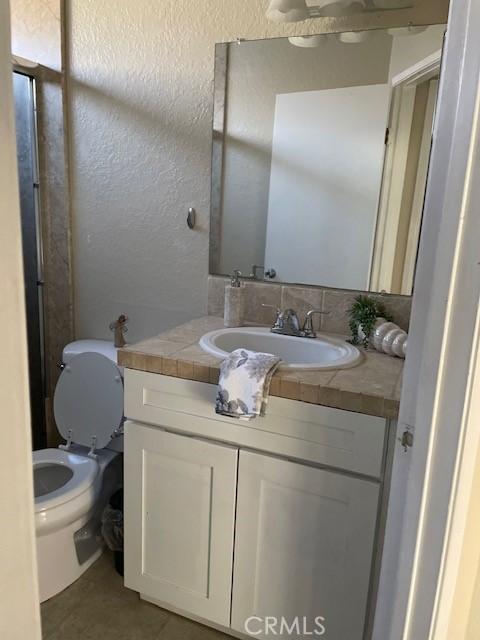 bathroom with vanity and toilet