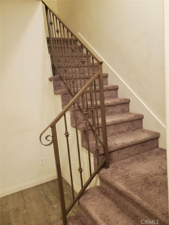 staircase featuring wood-type flooring