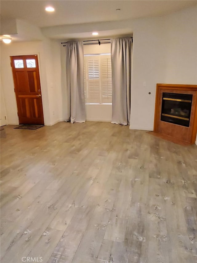 unfurnished living room with light wood-type flooring