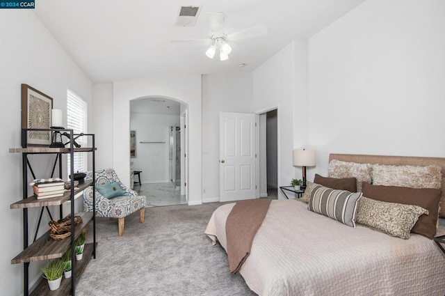 bedroom with carpet flooring, ensuite bathroom, and ceiling fan