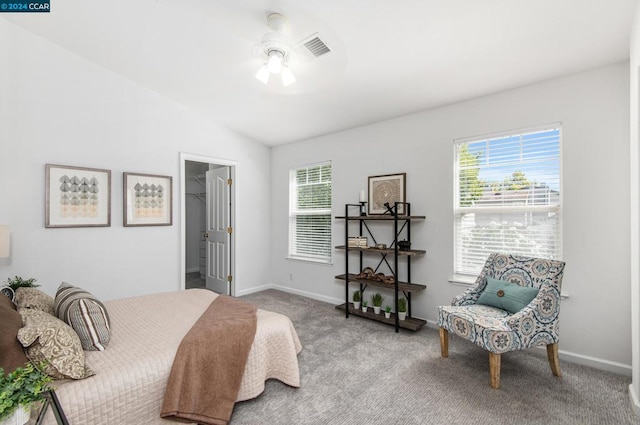 bedroom featuring a spacious closet, ceiling fan, light colored carpet, vaulted ceiling, and a closet