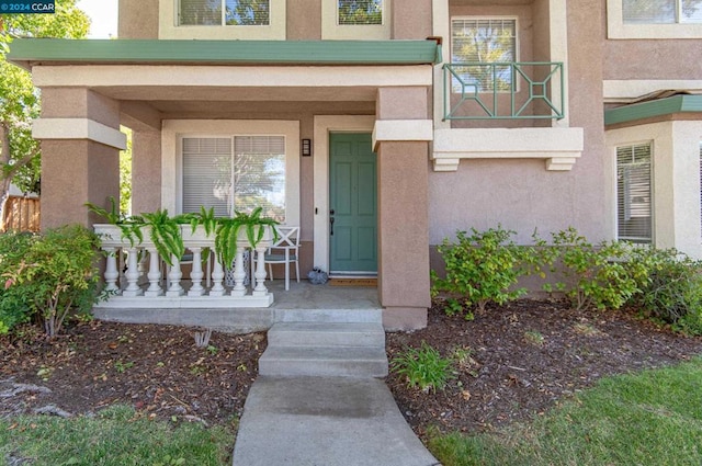 view of exterior entry with covered porch