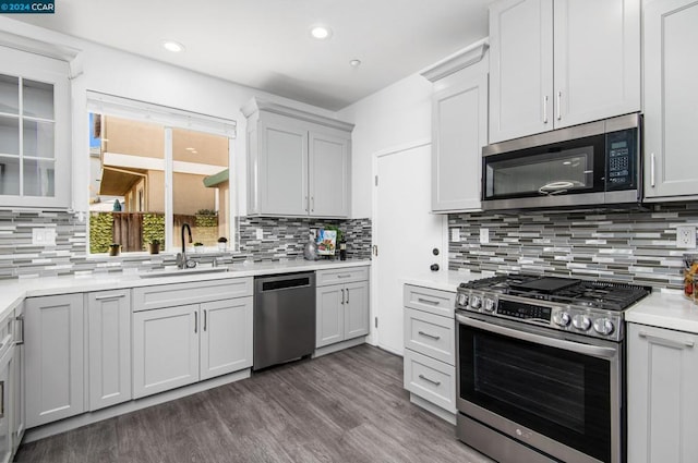 kitchen with decorative backsplash, white cabinetry, and appliances with stainless steel finishes