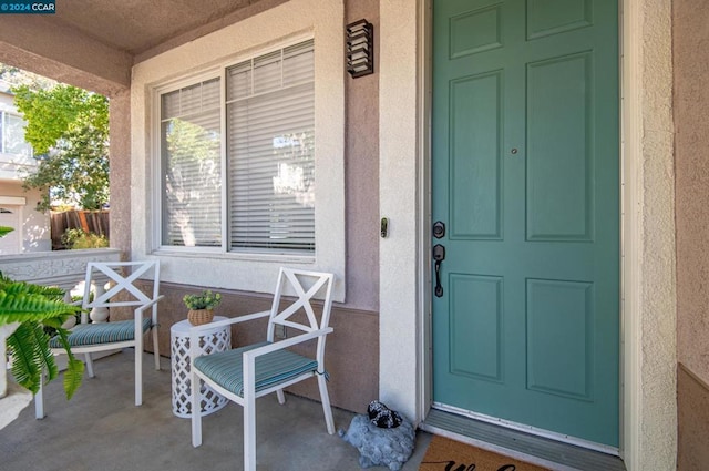 view of exterior entry with covered porch