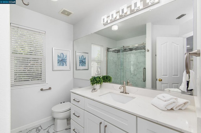 bathroom with vanity, toilet, and a shower with shower door