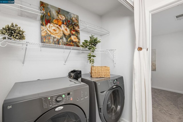 laundry area with separate washer and dryer and carpet